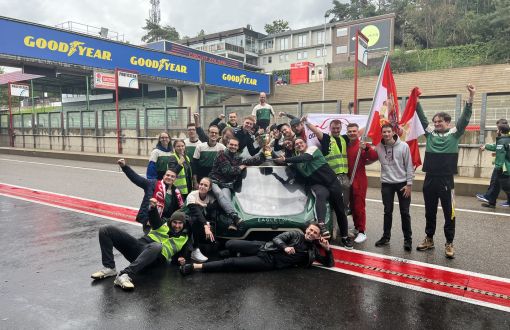 Grupa blisko 20 studentów z Lodz Solar Team cieszy się przy bolidzie ze zwycięstwa 